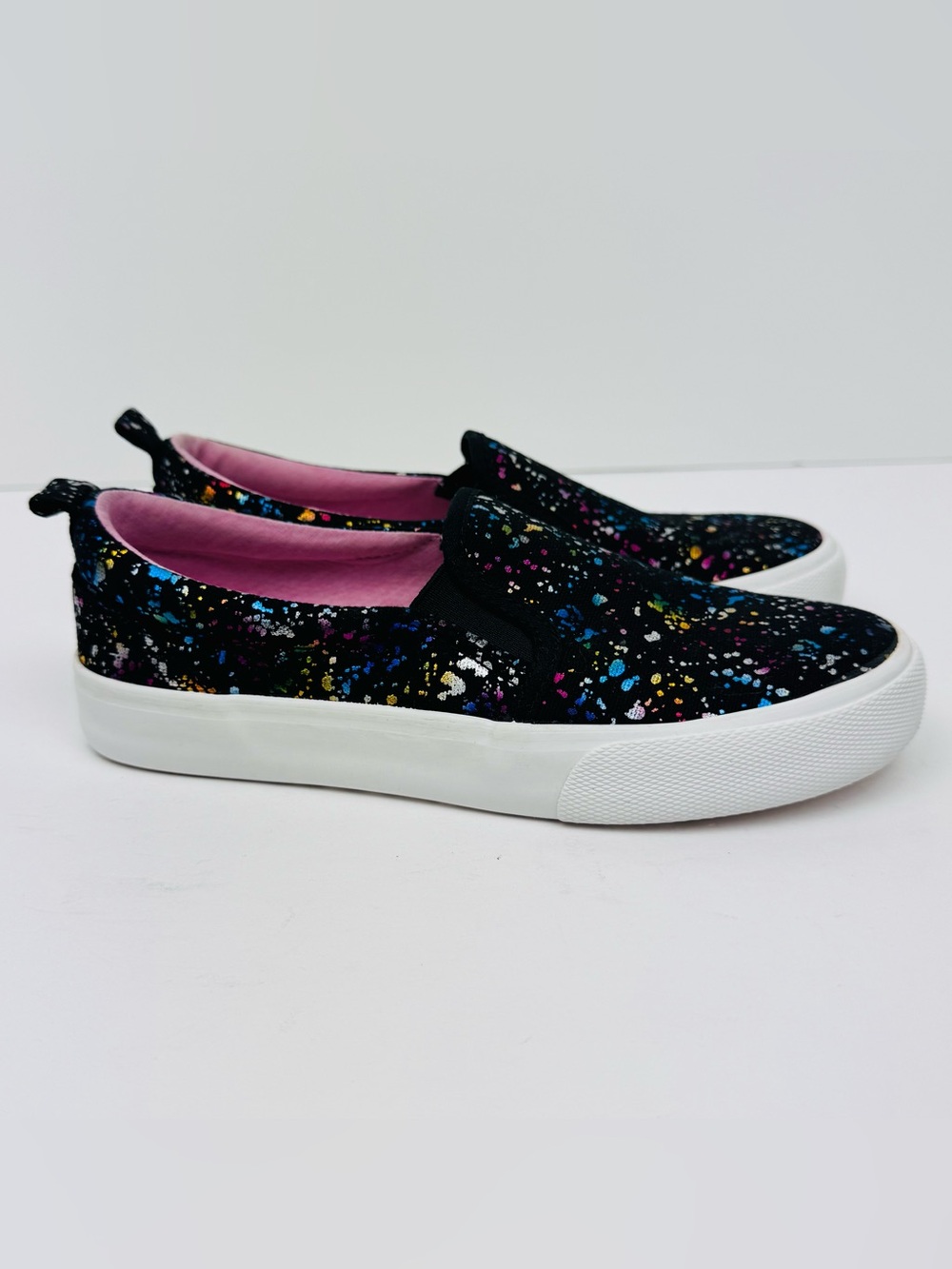 Cat & Jack slip on sneakers with a multicolor paint splatter design. Size 3.